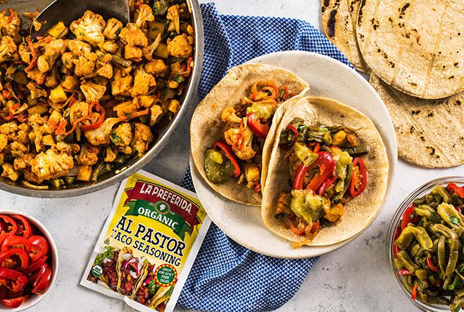 Vegetarian tacos filled with roasted cauliflower al pastor and toppings.