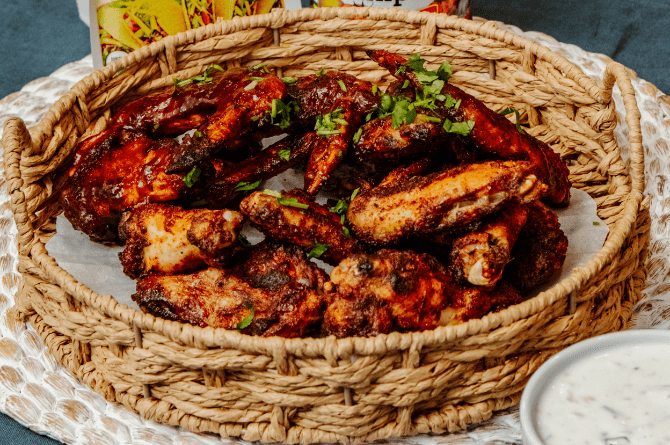 Chicken wings prepared 2 ways - Zesty Taco flavor and Tangy BBQ.