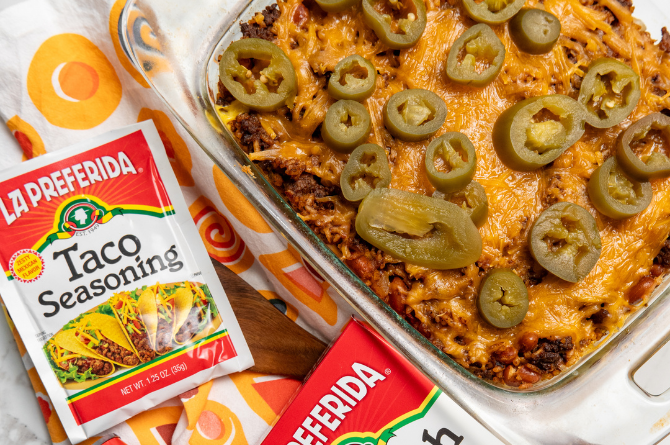 Beef burrito casserole baked with seasoned ground beef, Spanish rice, pinto beans, tortillas and melted cheese in a baking dish.