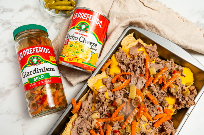 Italian beef nachos topped with giardiniera, melted cheese, and shaved beef on crispy tortilla chips